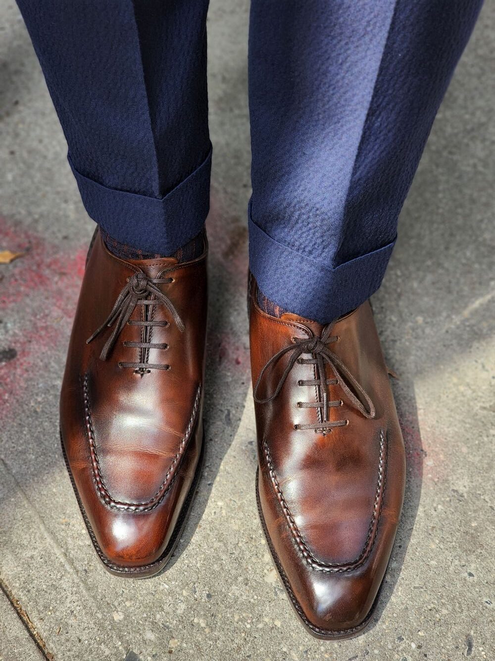 brown shoes with a navy suit