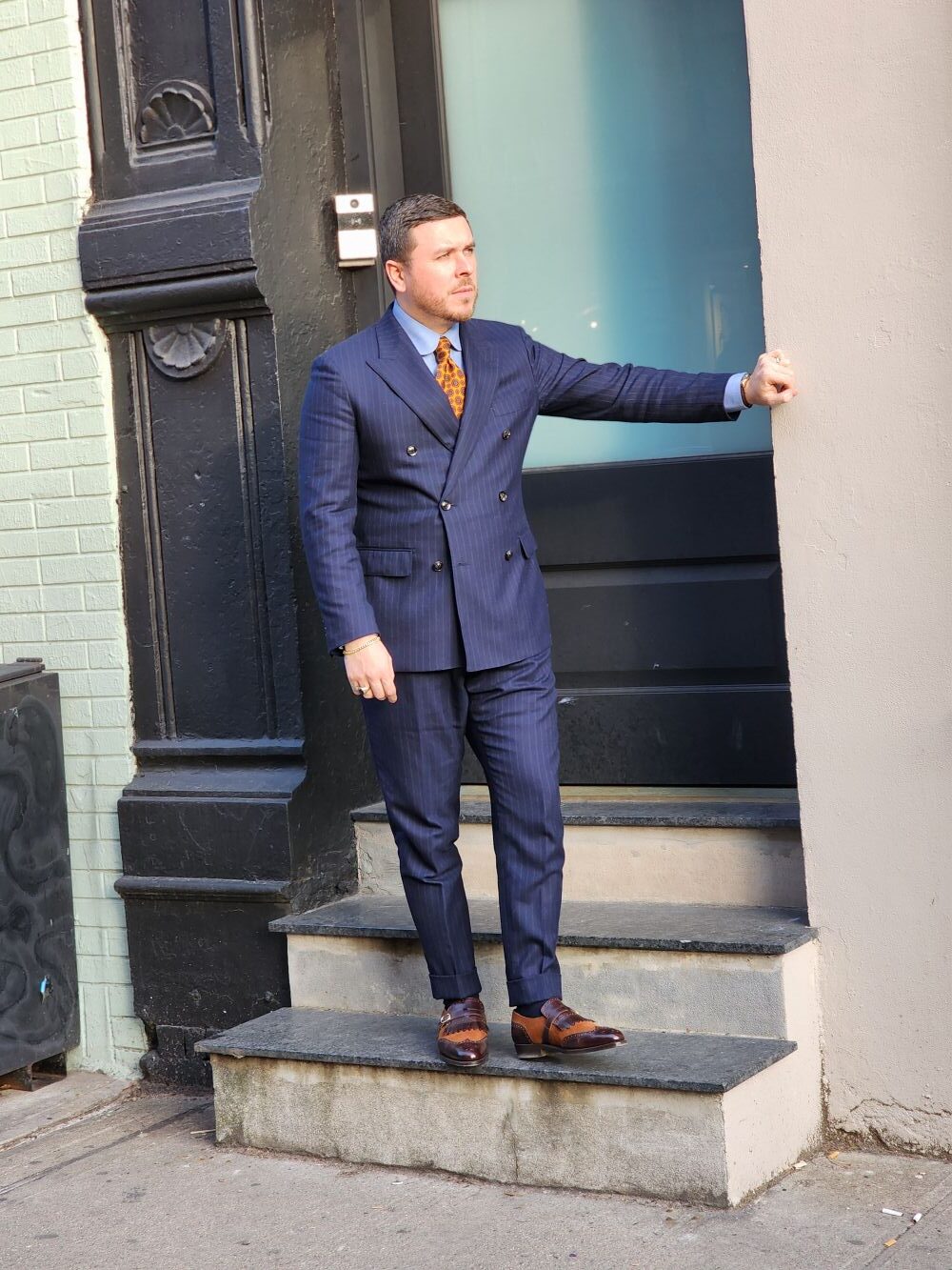 brown shoes with a navy suit
